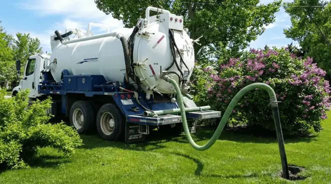 Professional vacuum truck performing residential drainage and septic maintenance in Santa Ana, CA