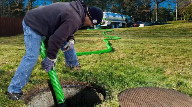 Service technician performing residential septic pumping and drainage maintenance in Santa Ana, CA
